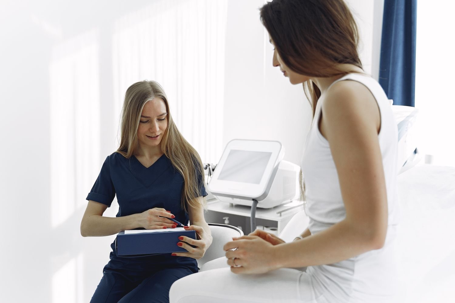 Clinician speaking with a patient; illustrative stock photograph